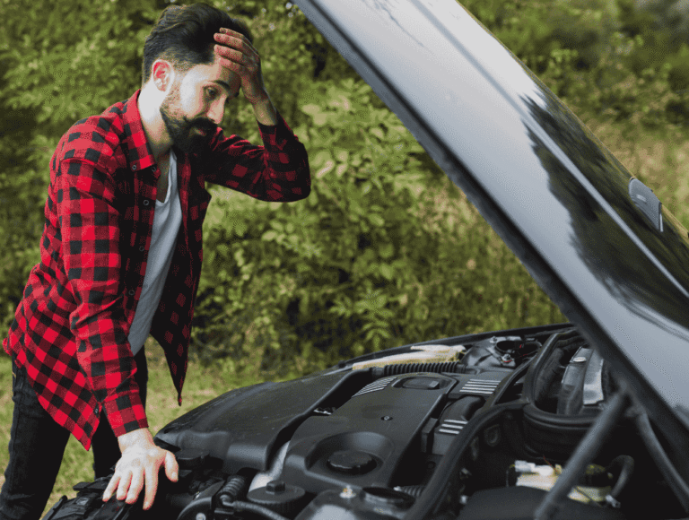 Man looking worried while checking an overheating engine and open the hood of car