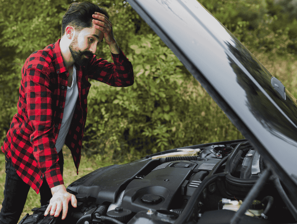 Man looking worried while checking an overheating engine and open the hood of car